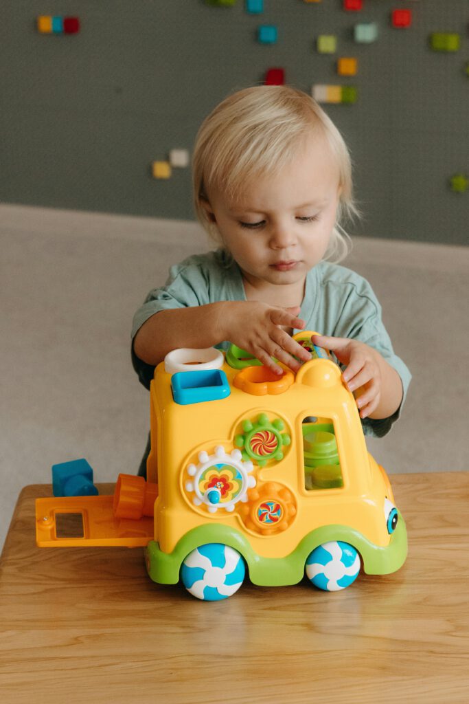 A small child playing with a toy truck